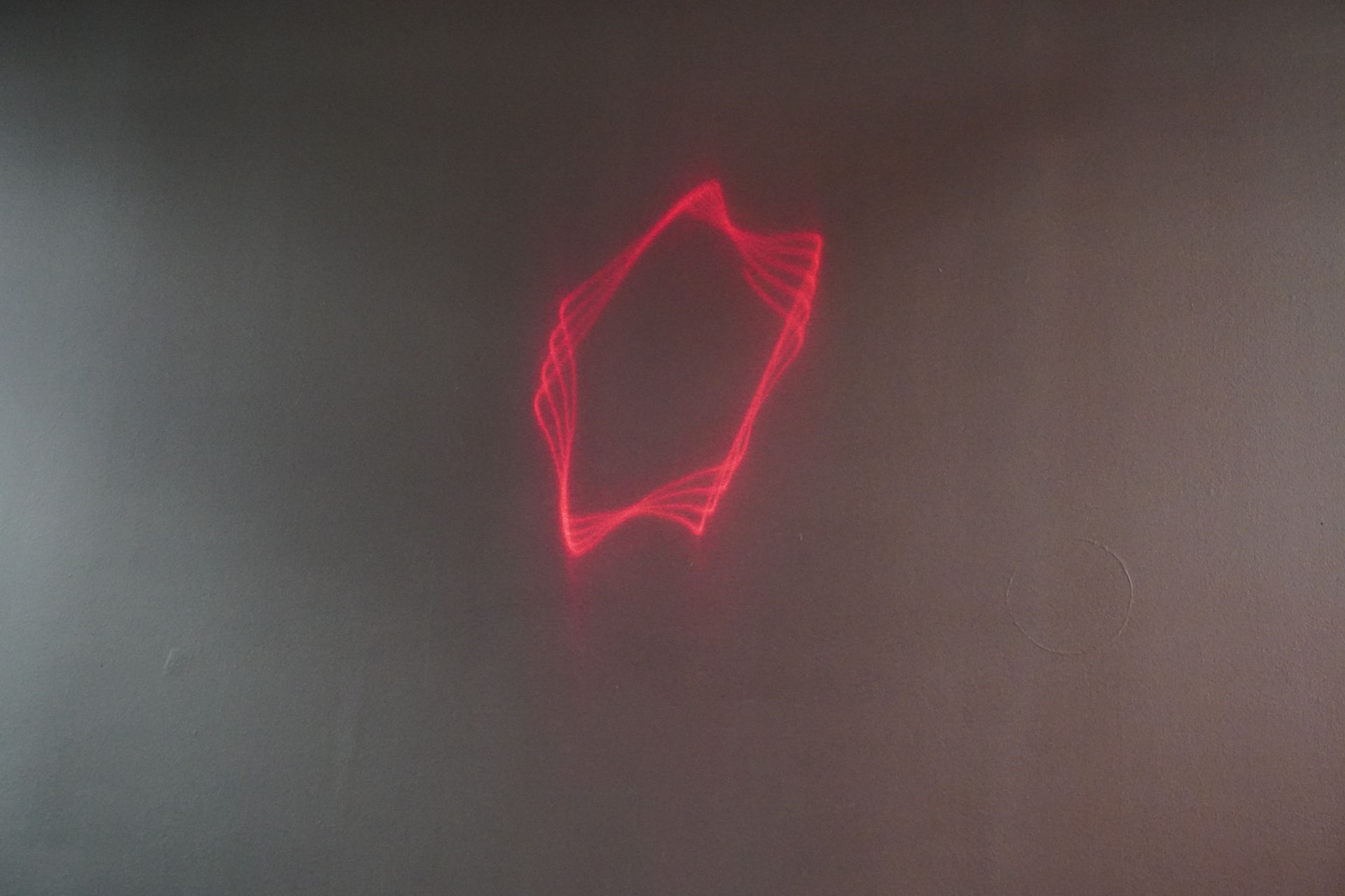 A red wave in star form projected on a wall