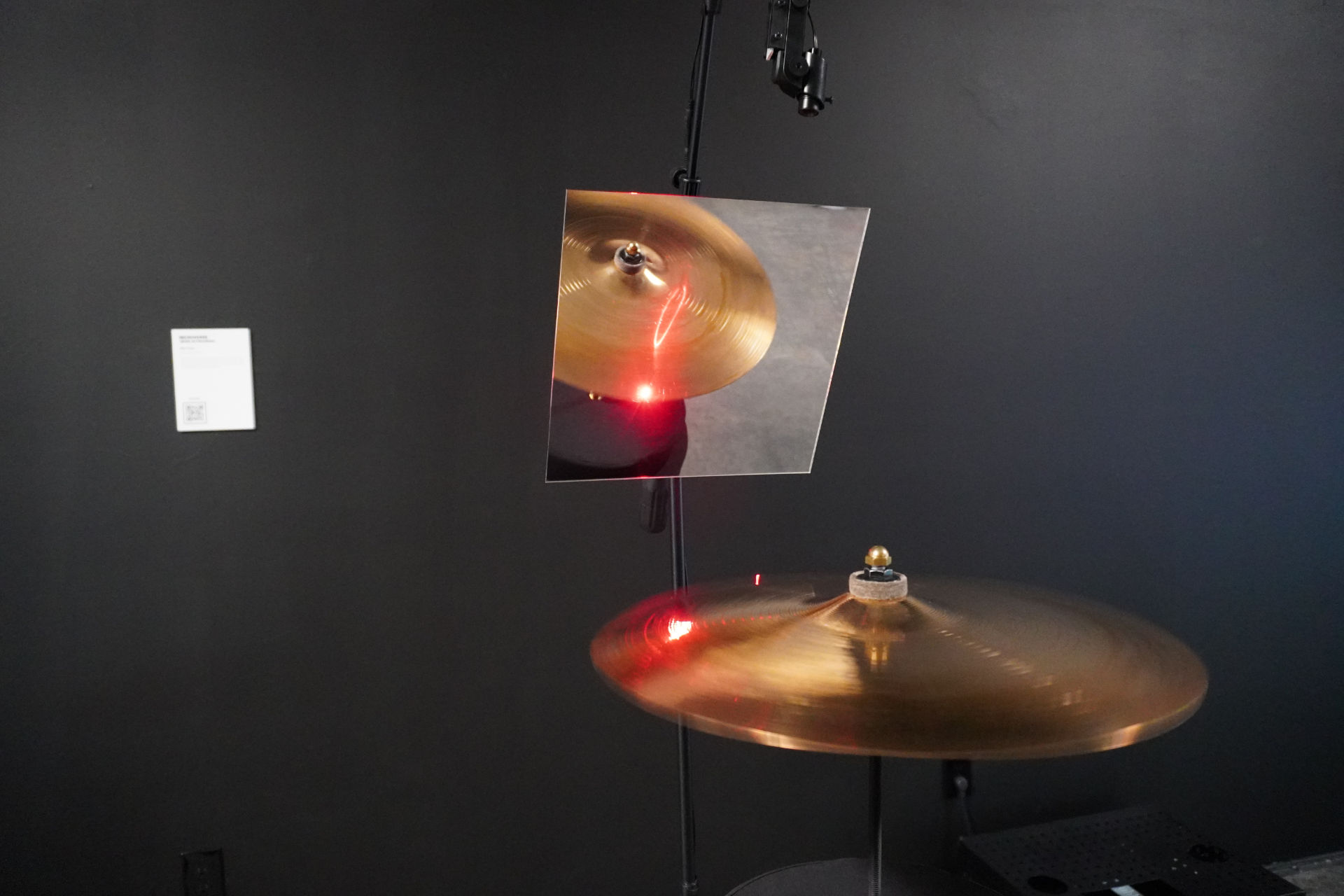 A hi-hat with a small red wave touching it, a representation of the Microverse artwork