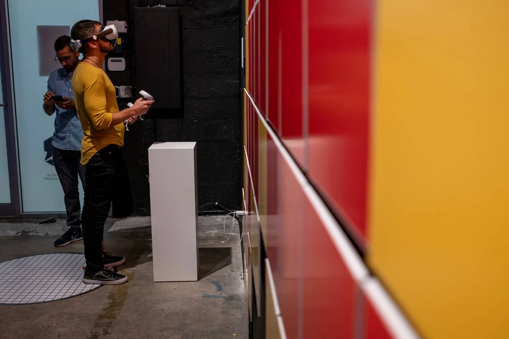 A person standing using an Oculus device, immersed in virtual reality