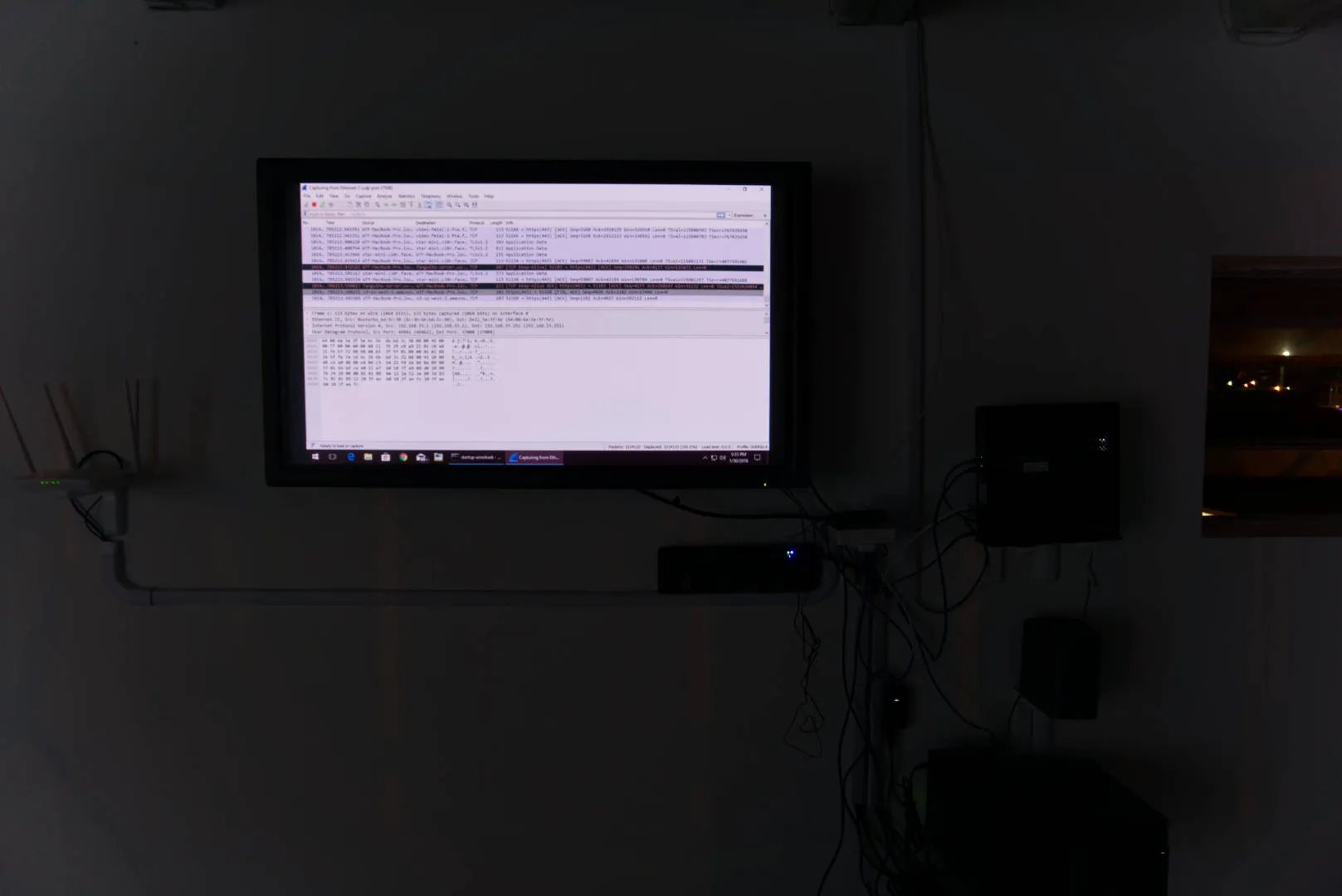 A dark room with a screen that shows Naked Link's Data Viz