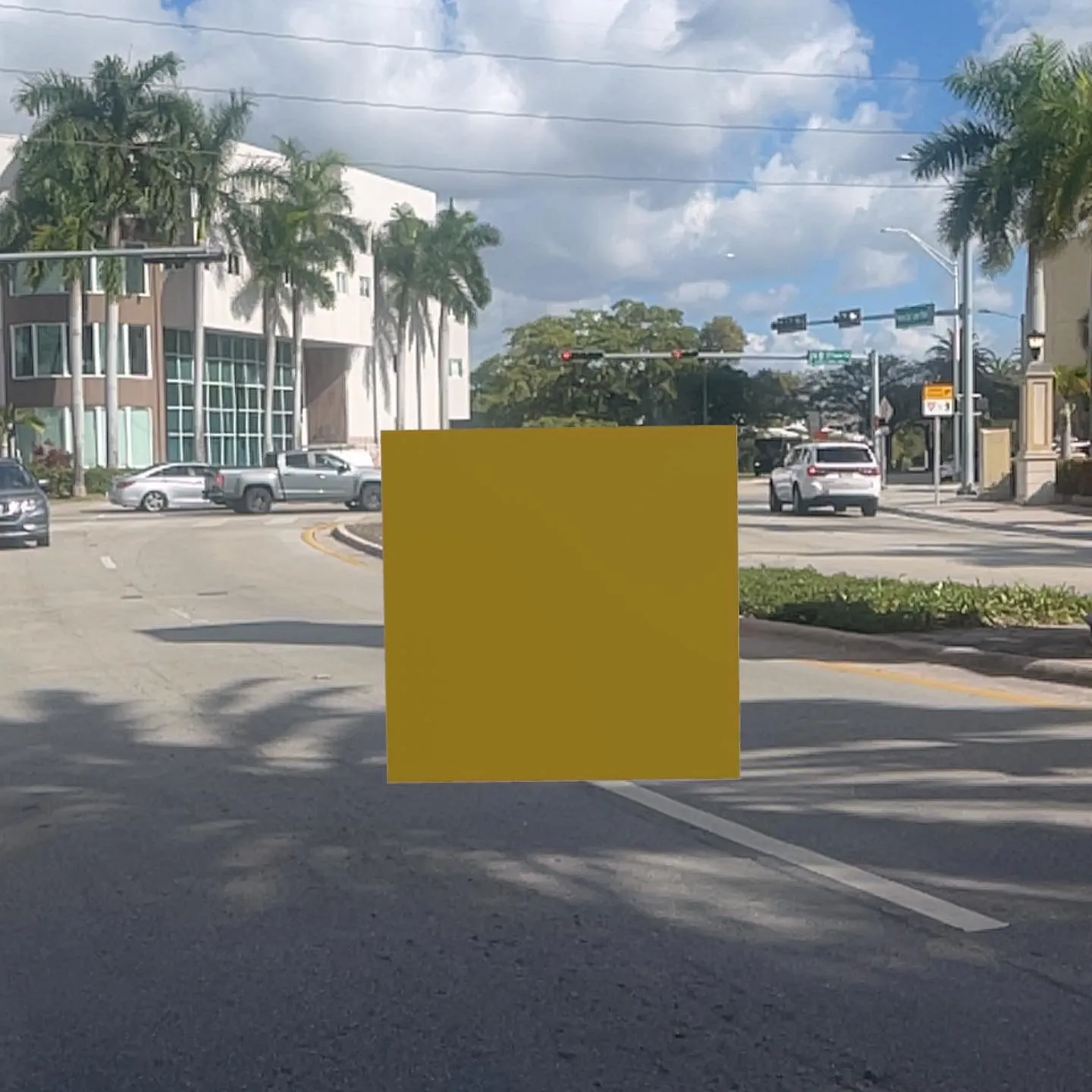 A yellow pixel, AR object positioned on a street