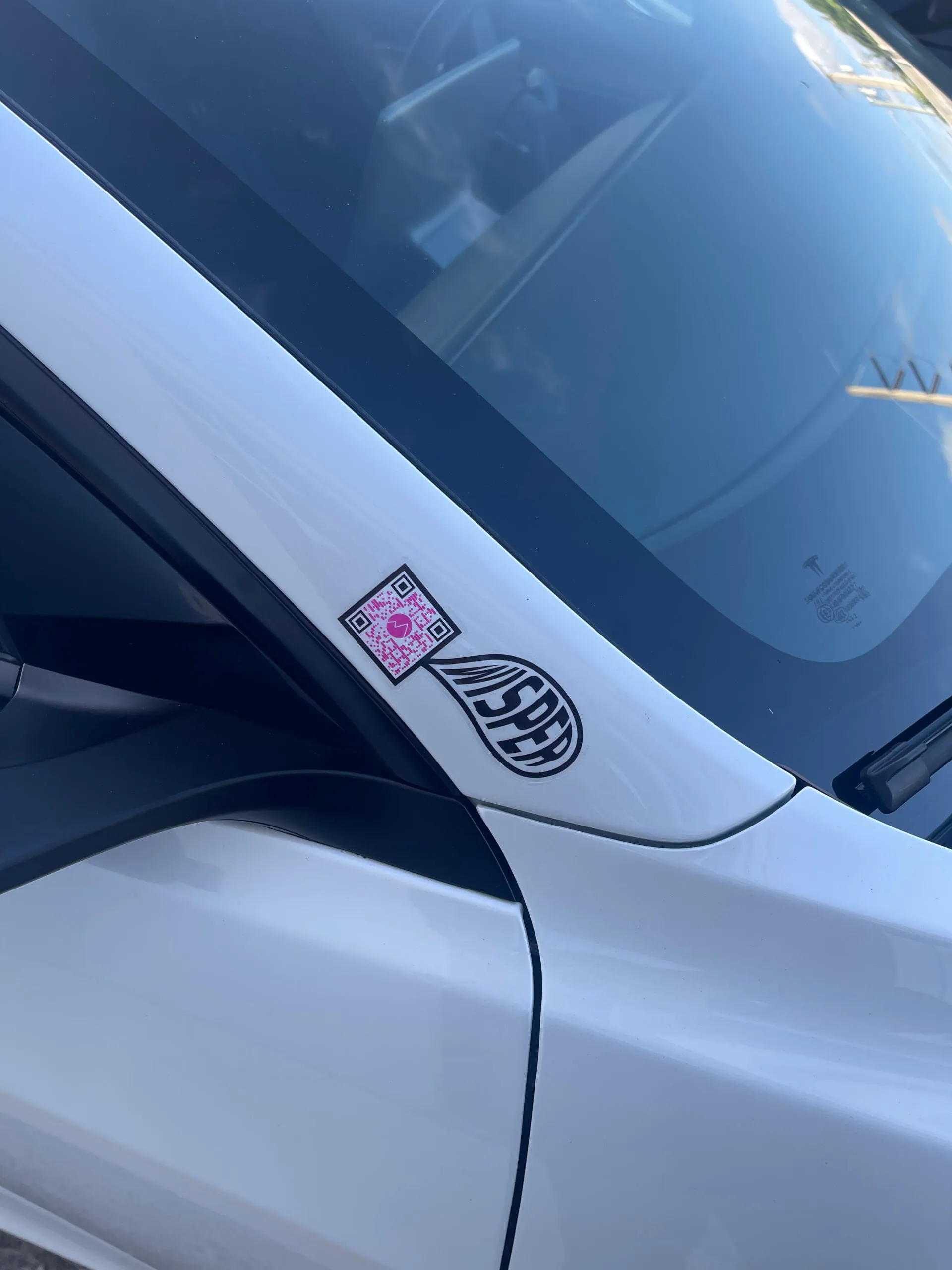 Wisper sticker on a white car