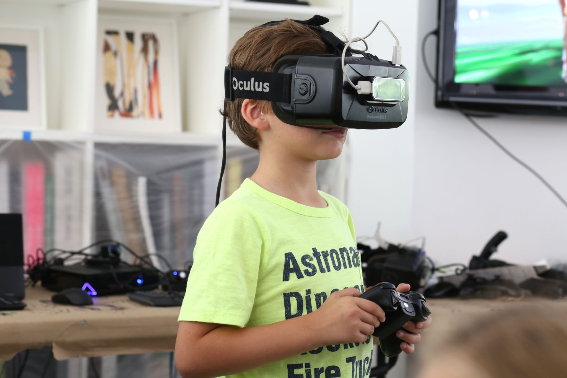 A kid using an Oculus and playing with a controller